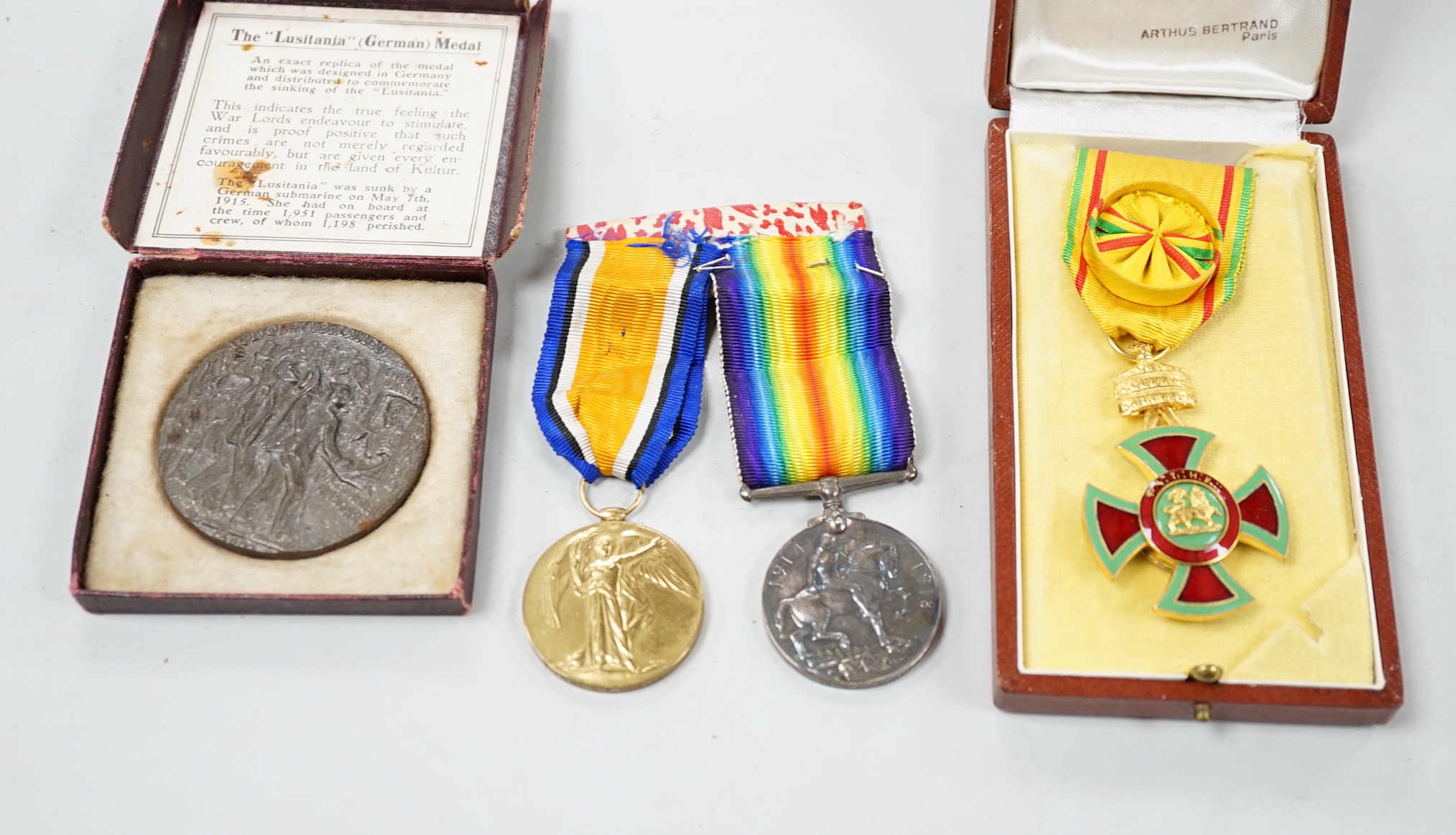 A cased presentation medal, together with a WWI medal pair and a cased RMS Lusitania medallion